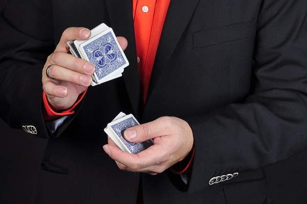 Ein Zauberer mischt ein Kartenspiel für einen Kartentrick.